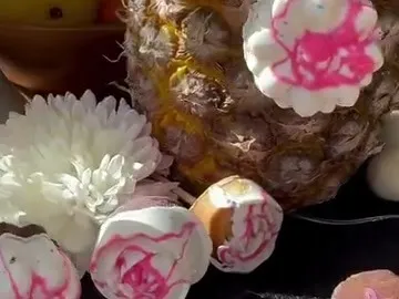 Flower-shaped cookie pops coated in pink and white chocolate