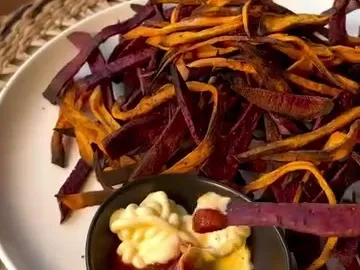 Baked orange and purple sweet potato fries with mayo and ketchup dip
