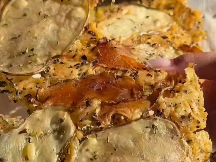 Thin potato slices baked into a crisp golden Parmesan crust