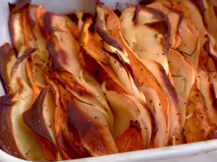 Thinly sliced sweet and white potatoes baked upright in a dish until the edges are crisp