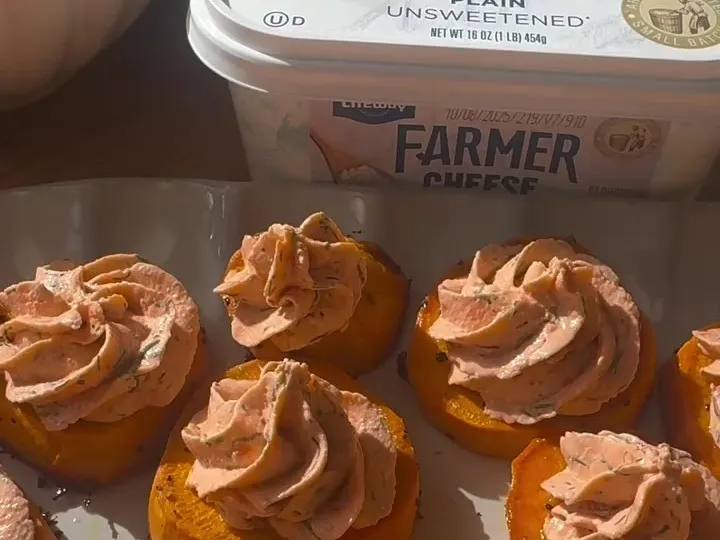 Sweet potato rounds piped with smoked salmon cheese cream, next to the farmer cheese tub