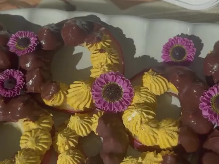 Apple ring donuts piped with pumpkin cream and half-dipped in chocolate