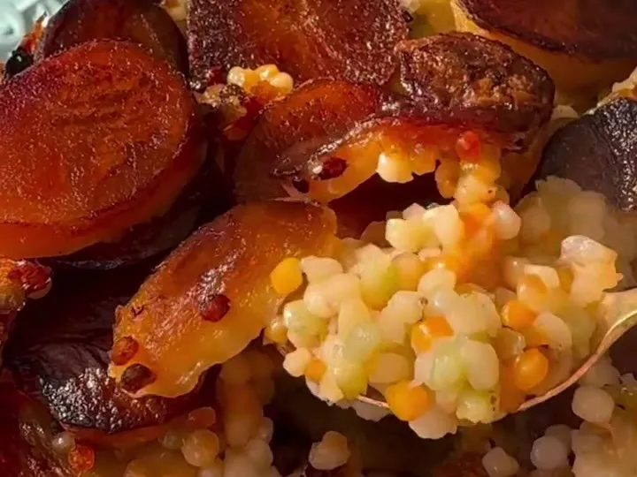 Couscous tahdig with a crisp golden potato crust on a serving plate