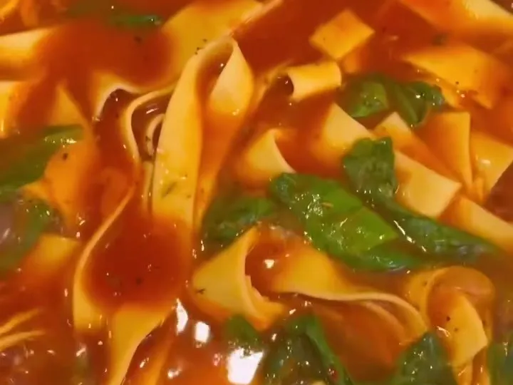 Pappardelle cooked in tomato sauce with basil and Kalamata olives