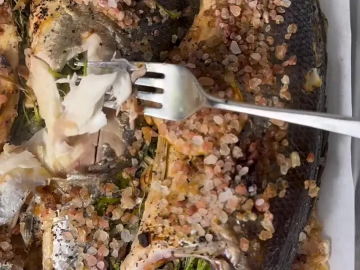 Salt-baked branzino with the salt crust cracked open
