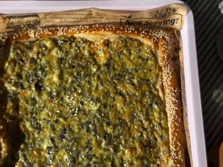 Baked spinach artichoke puff pastry tart in a baking tray