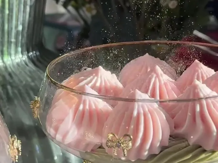 Strawberry and matcha mousse piped into a coupe glass with a pink bow
